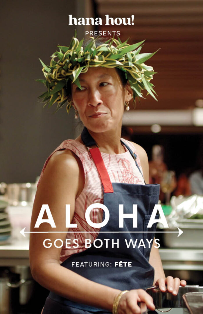 female chef with apron looks off camera in an elevated kitchen